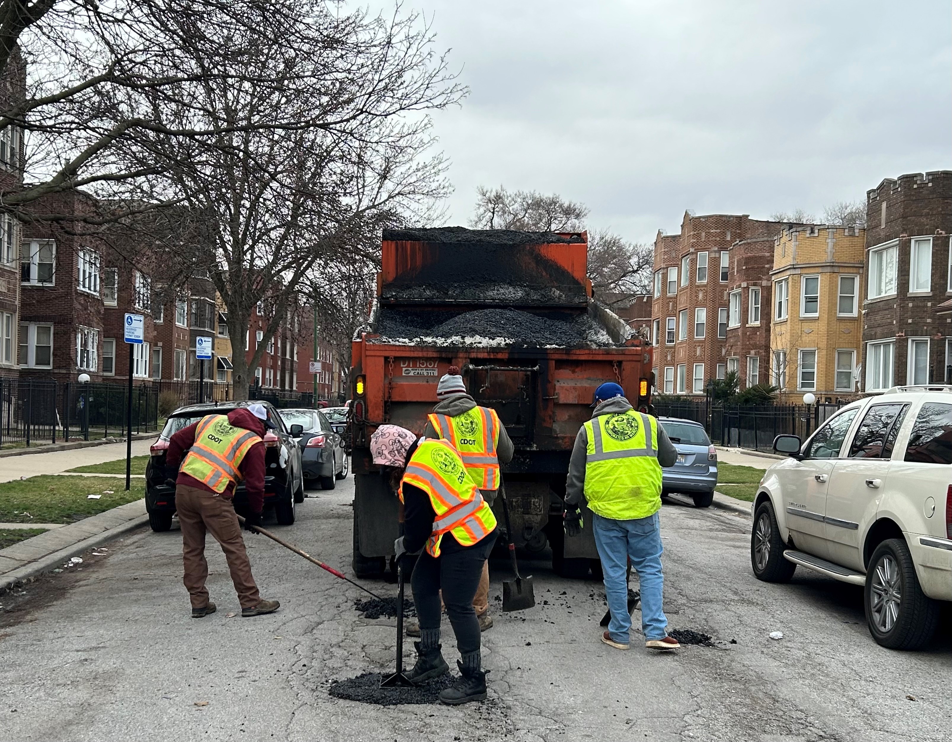 Photo of CDOT crews patching potholes on a street